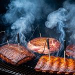 Smart meat thermometer with multiple probes monitoring temperatures inside a smoking chamber with rising smoke