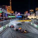 Formula 1 cars racing down the Las Vegas Strip at night during the Heineken Grand Prix
