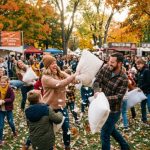 Families and friends enjoying a lively pillow fight outdoors at the 317 BBQ Broad Ripple event in Indianapolis on a fall afternoon