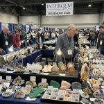 Colorful gemstones and crystal specimens displayed on vendor tables at the InterGem Rosemont Jewelry Show 2026